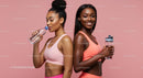 Active Women in Pink Sportswear Hydrating After Workout