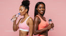 Active Women in Pink Sportswear Hydrating After Workout