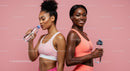 Active Women in Pink Sportswear Hydrating After Workout