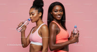 Active Women in Pink Sportswear Hydrating After Workout