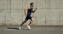 Athletic Man Running Along Concrete Urban Wall