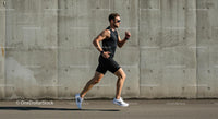 Athletic Man Running by a Concrete Wall