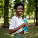 Smiling Woman Outdoors with Water Bottle in a Lush Park