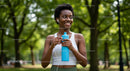 Woman Enjoying Outdoor Workout with Blue Water Bottle