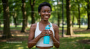 Woman with Water Bottle Enjoying Nature in the Park