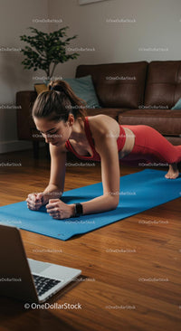 Woman in Red Activewear Performing Plank Exercise at Home