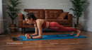 Woman in Red Outfit Holding Plank Pose in Cozy Living Room