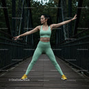 Woman Practicing Yoga Pose on a Bridge in Athletic Wear