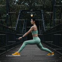 Woman Stretching on a Bridge in Sportswear