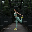 Woman Stretching on Iron Bridge in Green Activewear