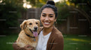 Happy Woman with Her Golden Retriever Mix in a Green Garden