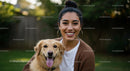 Smiling Woman with Golden Retriever in a Lush Garden