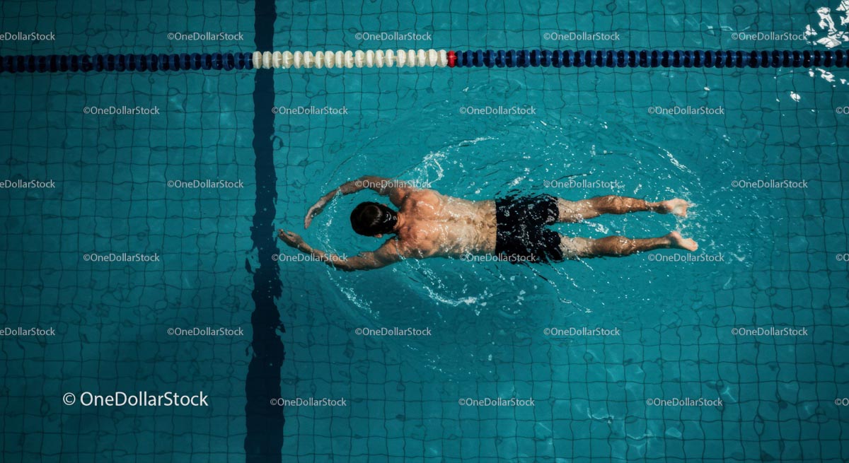 Top View of Man Swimming Freestyle in Blue Pool