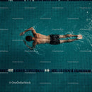 Male Athlete Freestyle Swimming in a Pool Lane