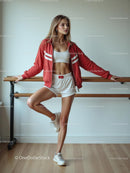 Woman in Sporty Outfit Leaning Against Ballet Barre