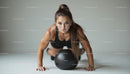 Focused Woman Performing Exercise with Medicine Ball
