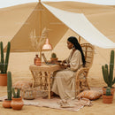 Woman Working on Laptop in Desert Oasis