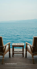 Tranquil Seaside Chairs on a Wooden Deck Overlooking Ocean