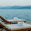 Elegant Wooden Lounge Chairs by the Tranquil Sea