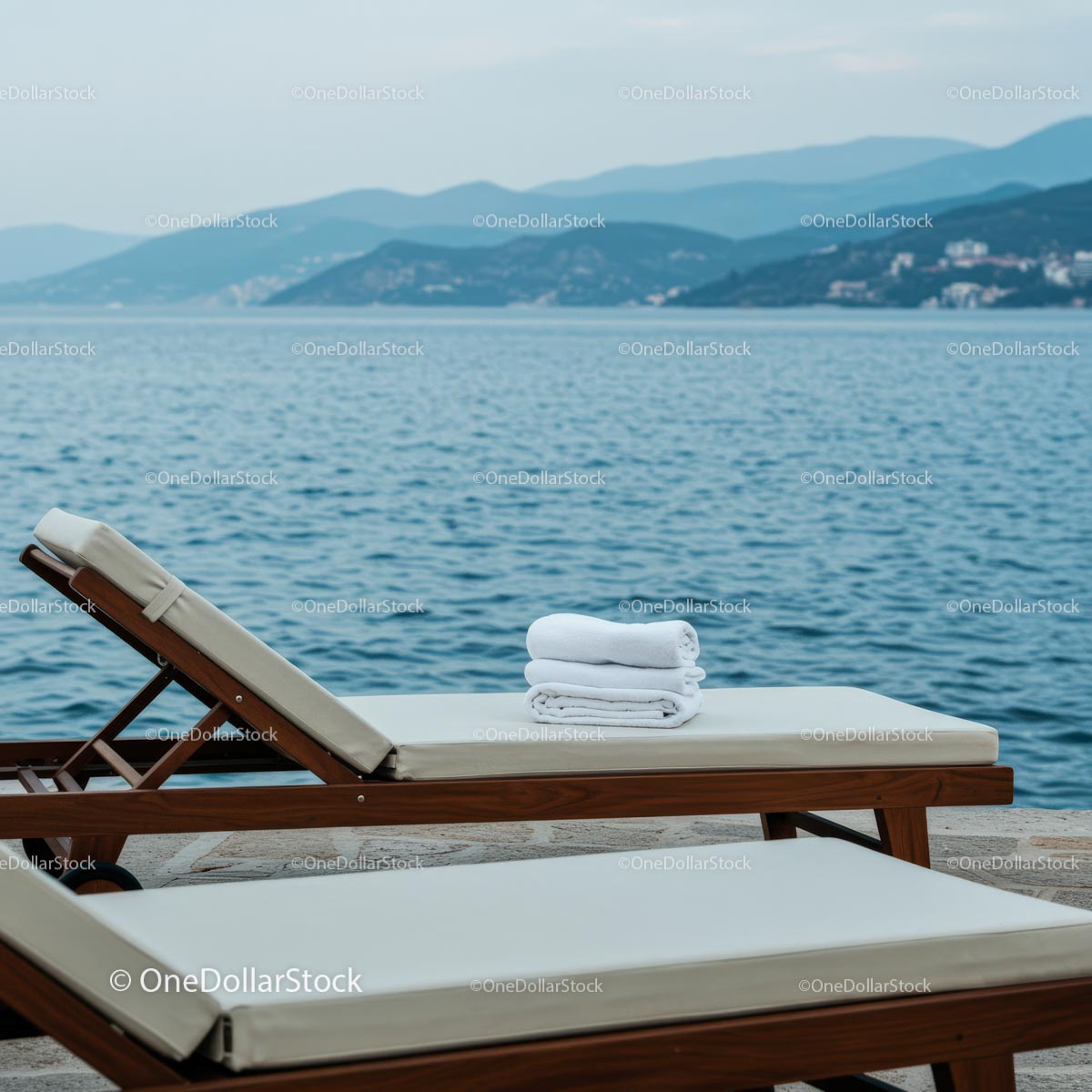 Serene Beachfront with Chaise Lounges and Mountain View