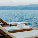 Luxurious Sun Loungers by the Serene Oceanfront
