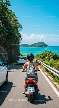 Woman Riding Scooter on Scenic Coastal Road