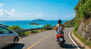 Woman on Scooter Riding Along Scenic Coastal Road