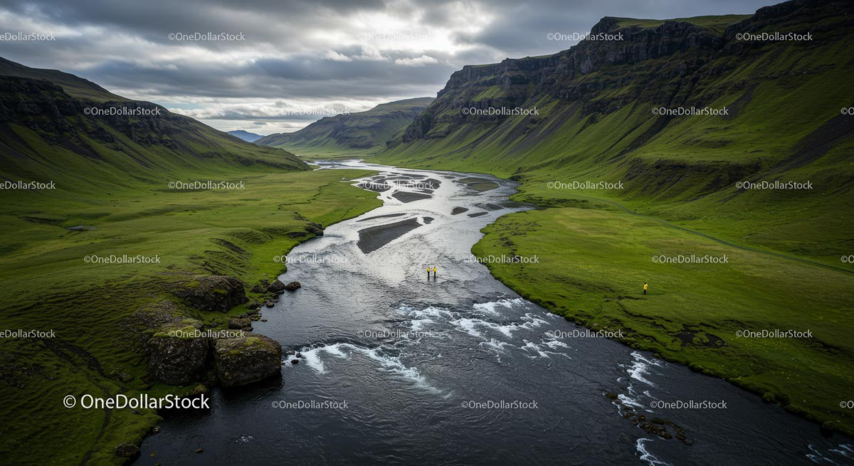 Dramatic River Valley with Lush Green Hills and Majestic Mountains