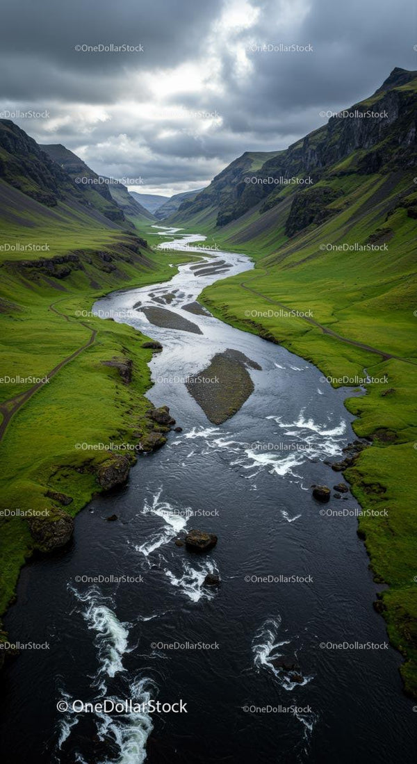 Winding River Through Verdant Valley Under Cloudy Skies