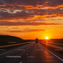 Truck on a Highway During Vibrant Orange Sunset