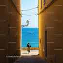 Bicyclist in a Narrow Alley Overlooking the Sea