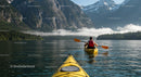 Kayaker Exploring Serene Mountain Lake with Misty Peaks