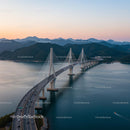 Spectacular Suspension Bridge at Sunset Over Calm Waters
