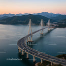 Sunset View of Cable-Stayed Bridge and Mountains