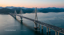 Suspension Bridge at Sunset with Mountain Backdrop