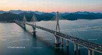 Suspension Bridge at Sunset with Mountain Backdrop