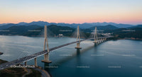 Cable-Stayed Bridge Over Tranquil Waters at Sunset