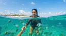 Woman Snorkeling Amidst Colorful Tropical Fish in Clear Water