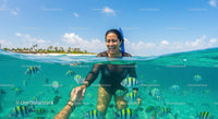 Woman Snorkeling Amidst Colorful Tropical Fish in Clear Water