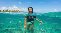 Woman Snorkeling with Tropical Fish in Crystal Clear Waters