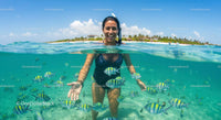 Woman Snorkeling with Colorful Fish in Tropical Waters