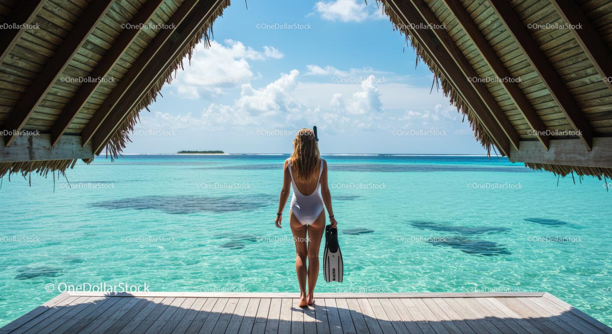 Woman with Snorkel Gear Overlooking Tropical Lagoon
