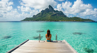 Woman Relaxing on Tropical Island Dock with Mountain View