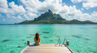 Woman Relaxing on Dock Overlooking Tropical Island