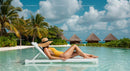 Woman Relaxing Poolside at Tropical Beach Resort
