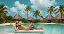 Woman Relaxing Poolside at Tropical Beach Resort