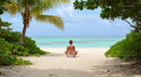 Woman Meditating on Tranquil Tropical Beach with Palms