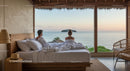 Couple Relaxing in a Bedroom with Stunning Ocean View