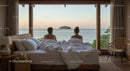Couple Relaxing with Ocean View in Cozy Bedroom