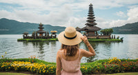 Woman in Hat Admiring Ulun Danu Bratan Temple in Bali
